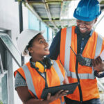 Shot of a young man and woman using a digital tablet while working at a construction site